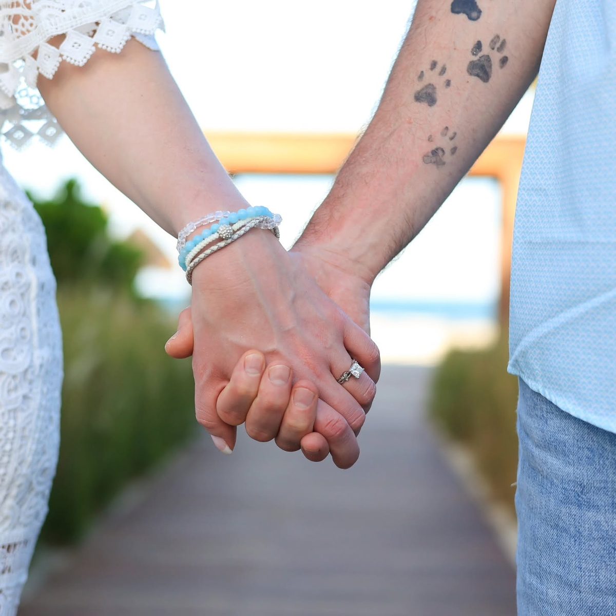 Close-up of Jackie and Jered holding hands, engagement ring catching the light