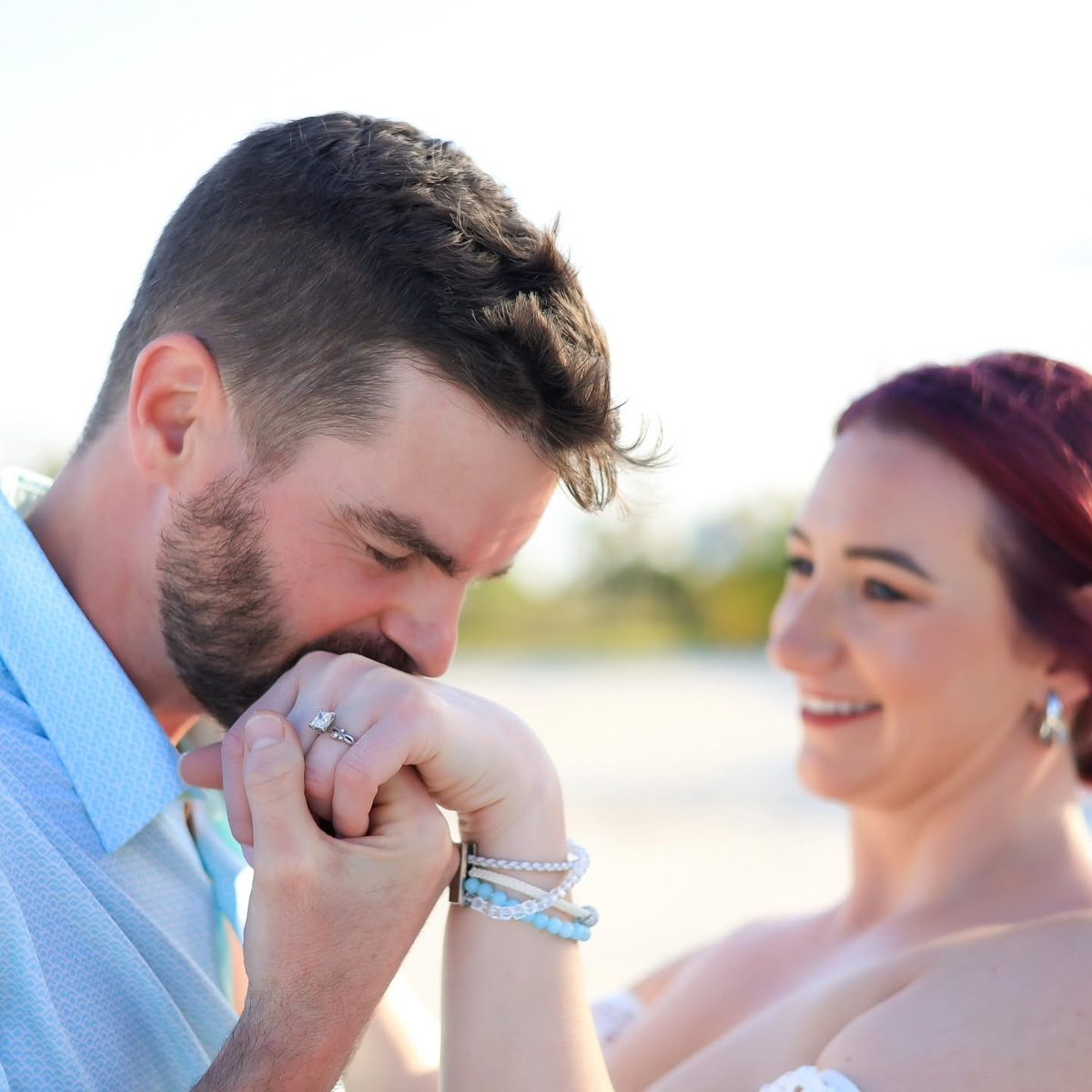 Jered kissing Jackie's hand as she smiles